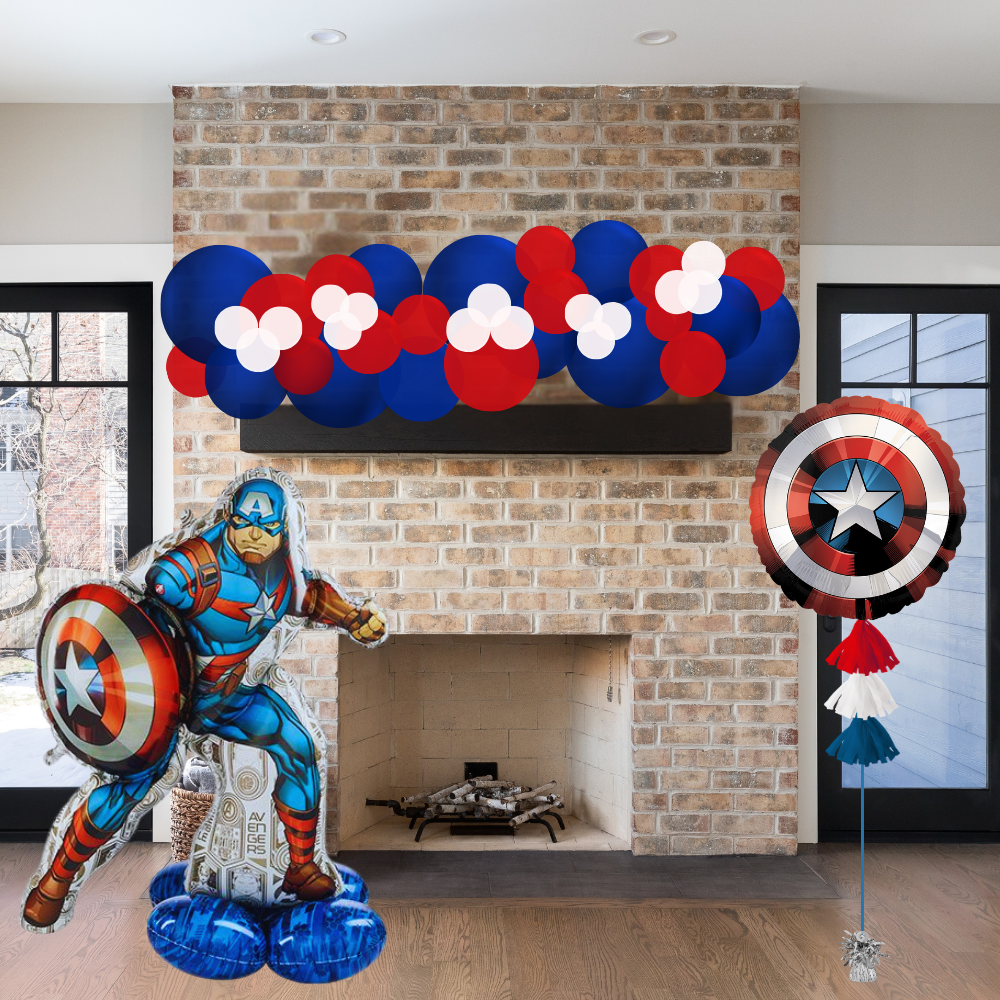 Decorative balloons shaped like Captain America and a shield, with a brick fireplace in the background.
